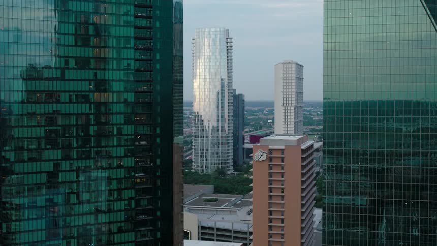 View of a city with several tall buildings some with reflective glass facades and others with concrete exteriors