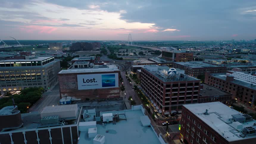 Aerial panorama of an urban city against a blue and pink sky