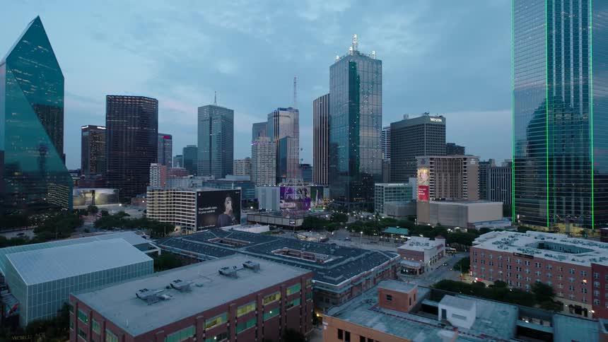 Aerial view of a cityscape during twilight with highrise buildings