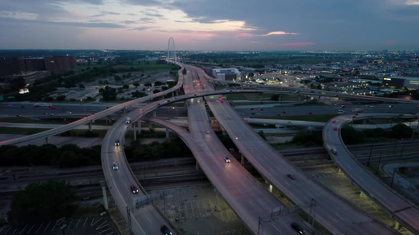 Scene of intersections and highways in a metropolis with vehicle traffic in the early evening