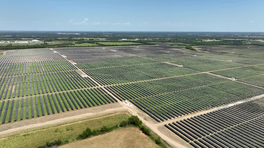 Aerial view of a large field with solar panels