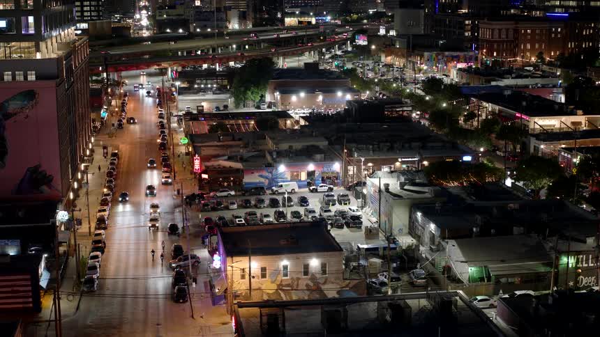 Aerial view of an urban city seen at night with vehicle traffic