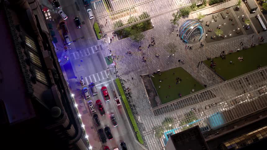 Aerial view of a metropolis and a square with several people