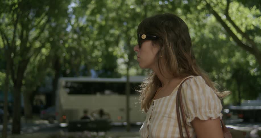 Woman with black sunglasses walking in the city