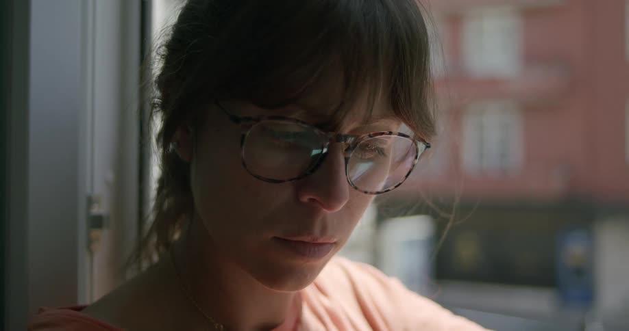 Portrait of a woman with prescription glasses looking down