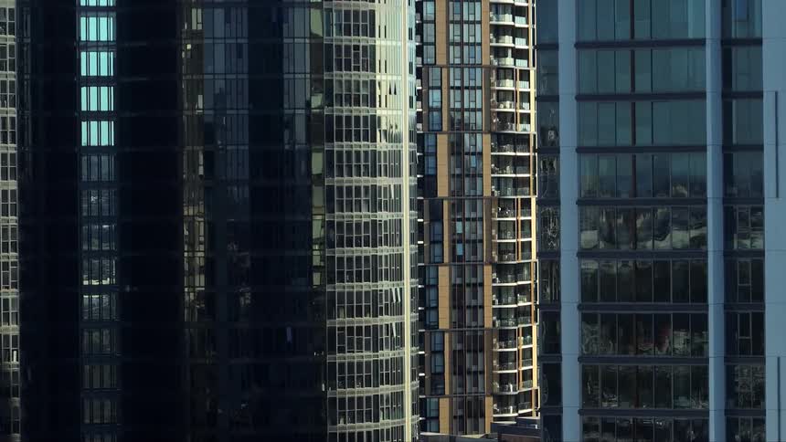 Tall modern buildings with reflective glass facades