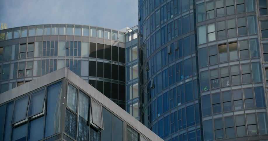 Modern building facade features reflective glass windows and curved architectural details