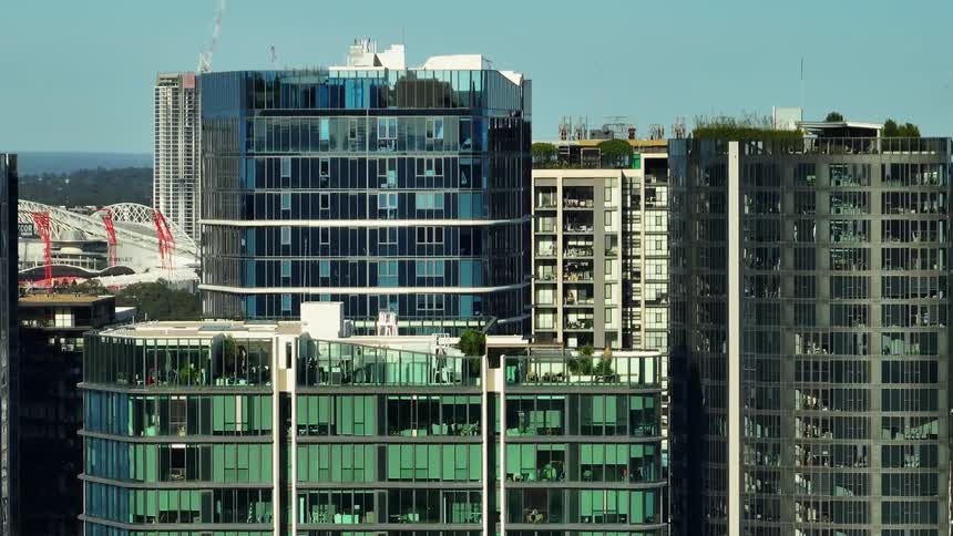 A closeup view of modern highrise buildings with reflective glass facades