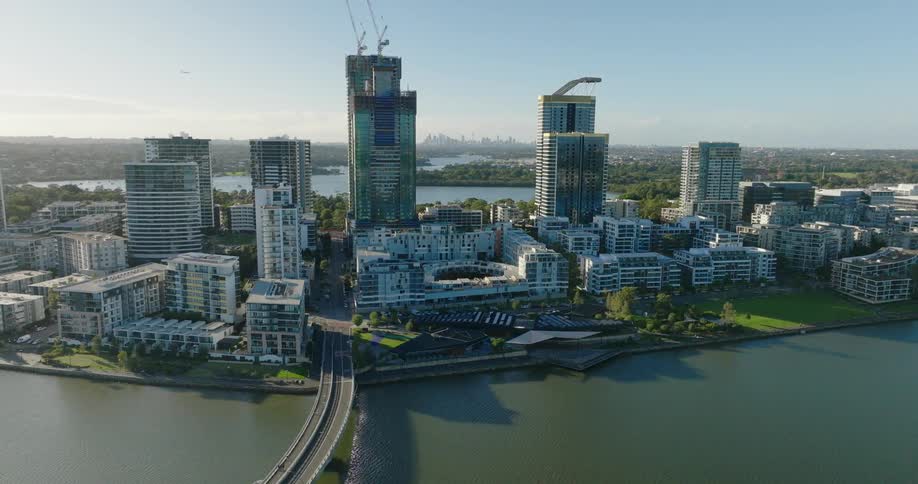 Aerial view of an urban city with modern skyscrapers surrounded by a sea canal