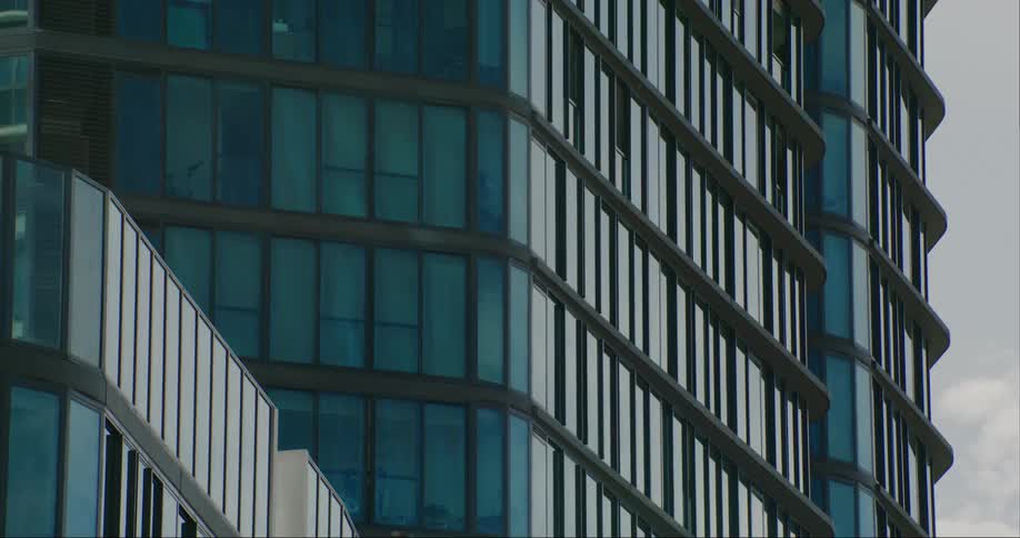 Exterior architecture of the side of a building with standard and modern windows