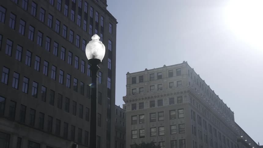 Lamppost in a metropolis with buildings in the background