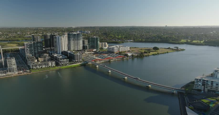 Aerial view of a bridge above the sea that connects metropolises with modern buildings