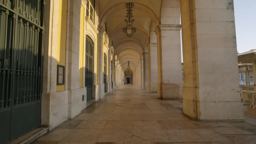 Long hallway with arched ceilings and a series of doors to the left