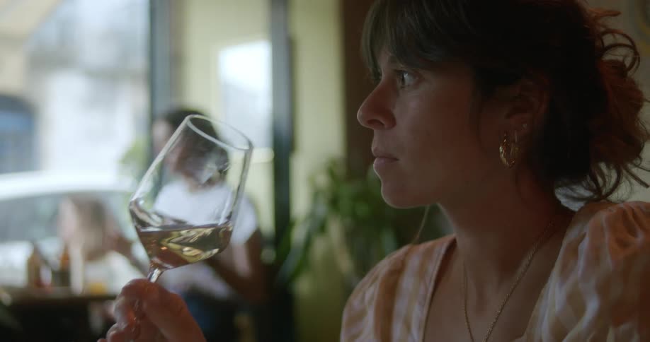 Young woman drinking a glass of white wine
