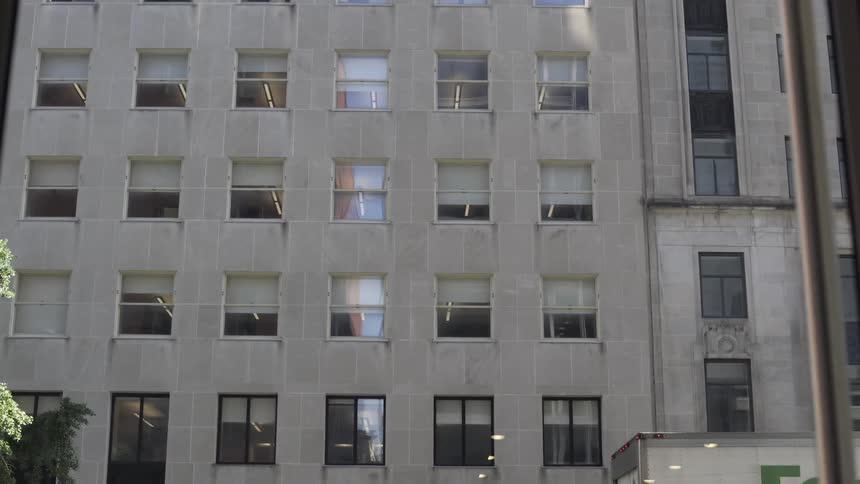 Facade of a gray building with patterned windows in a metropolis