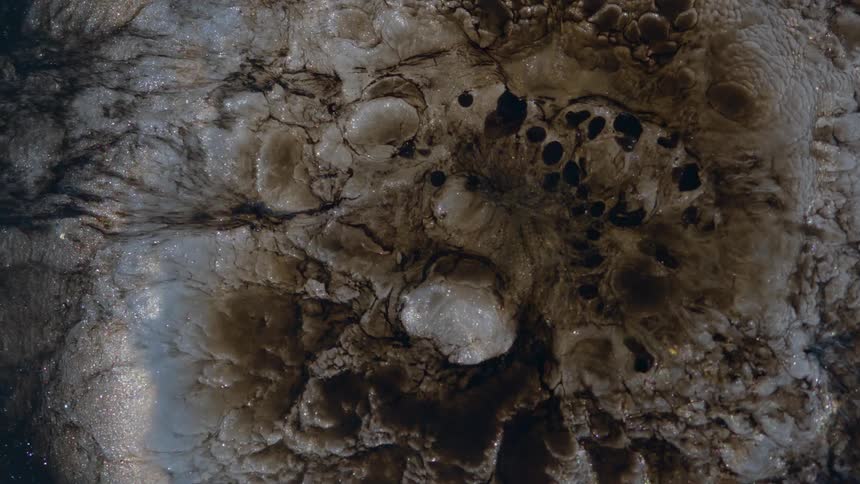 Extreme close up of a dense abstract liquid expanding and contracting