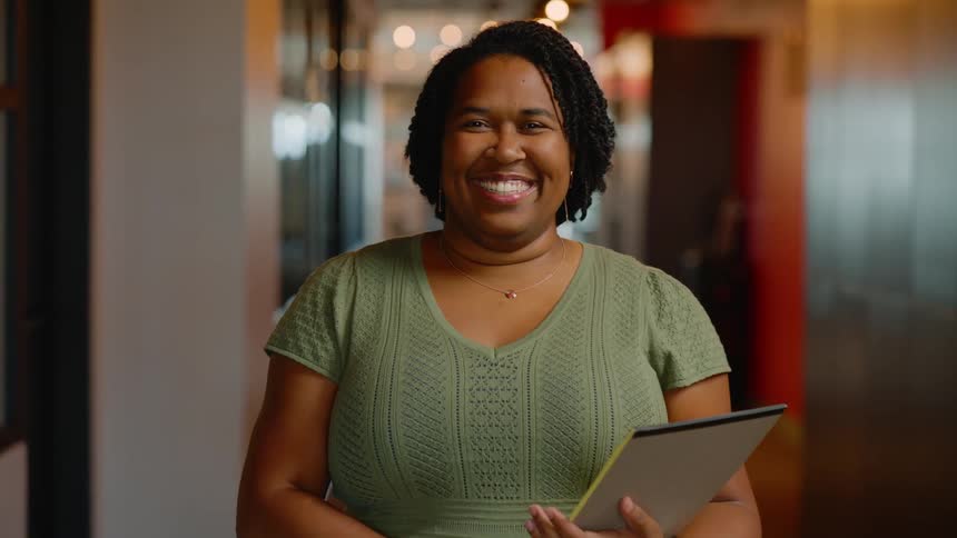 Cheerful woman smiling in a hallway