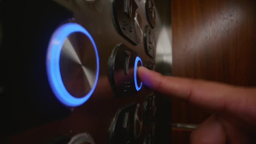 Finger clicking on an elevator button