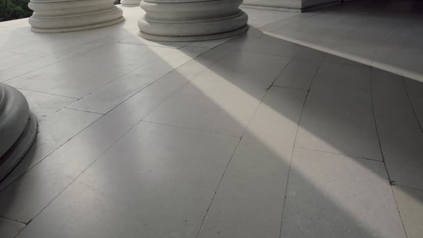 Closeup view of a floor inside a building with large columns
