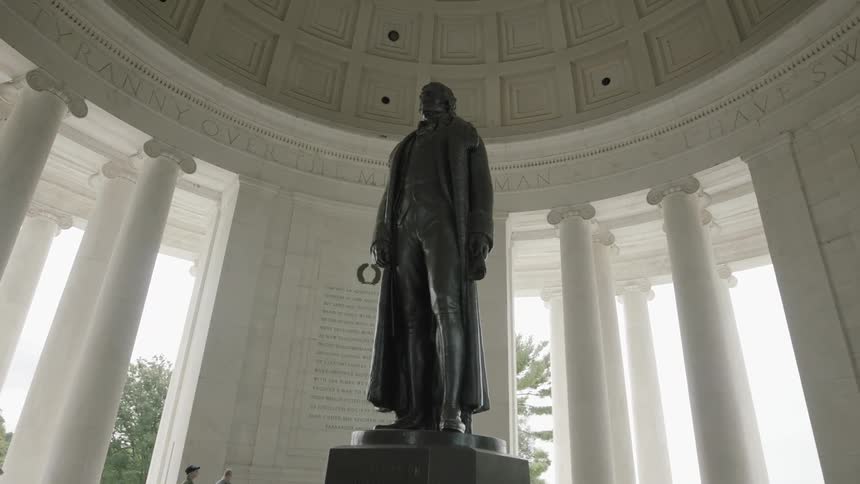 Large statue in the center of a classical museum