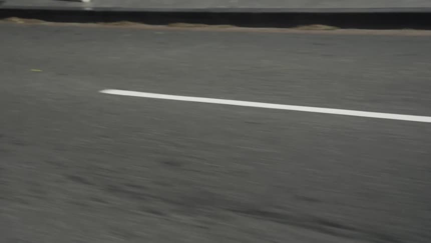 Moving view of a paved street in the city