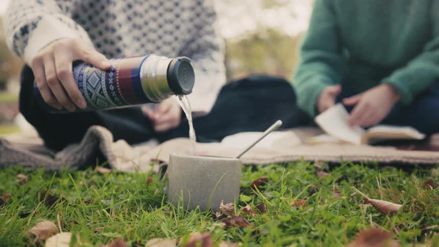 A clip of a person pouring a drink into a cup