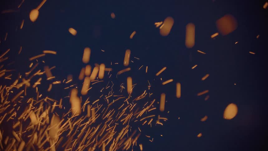 Sparks of fire against a dark blue sky