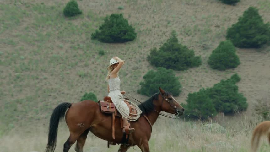 A man and woman are horseback riding together