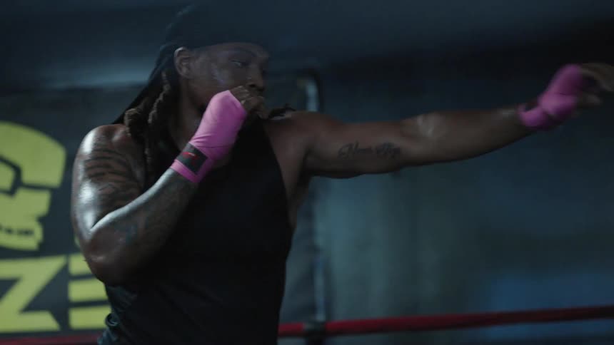 Three boxers move around throwing air punches in a gym
