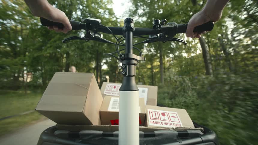 A person is delivering packages with their cargo bicycle POV