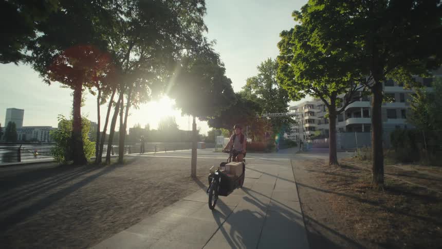 A clip of a person transporting packages on a bicycle