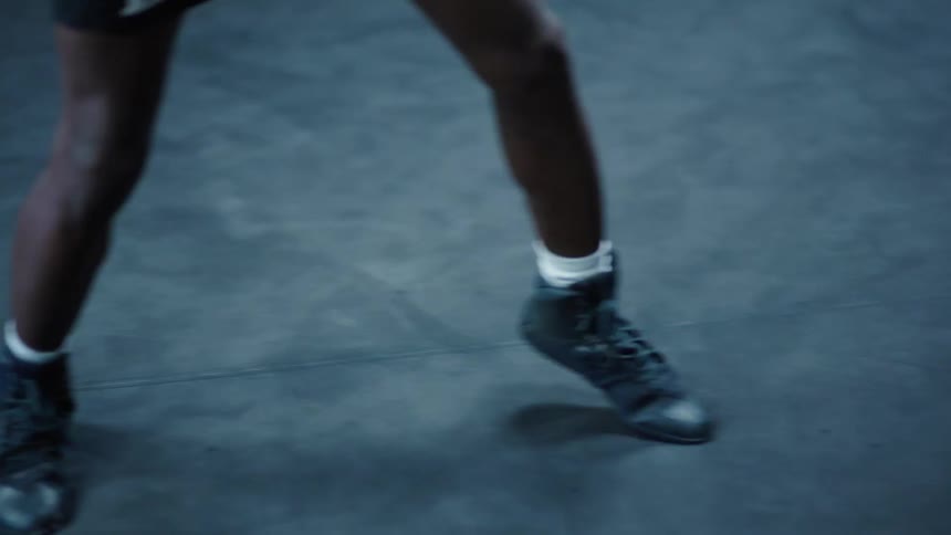 Teenager training inside a boxing ring