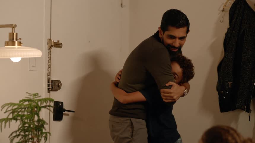 A clip of a son embracing his father when he arrives home