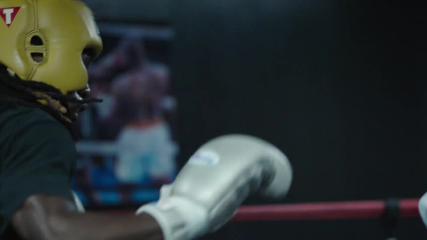A close up clip of boxers fighting in the ring