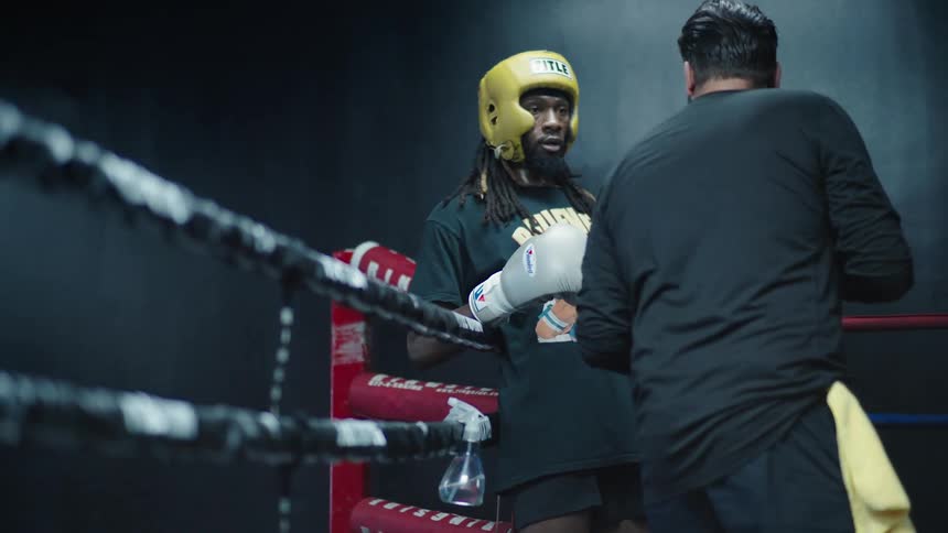 Two men talking in a boxing training inside a ring