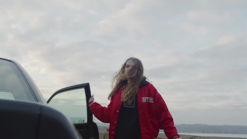 Teen girl slams car door and moves toward her goal