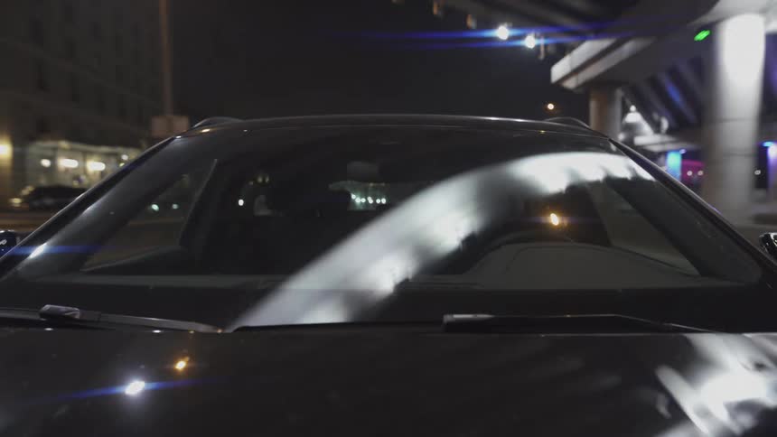 Man driving a car through the city