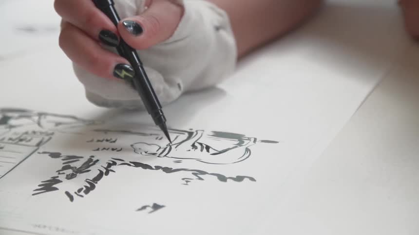 A woman with a bandage on her hand draws a dog with a pen