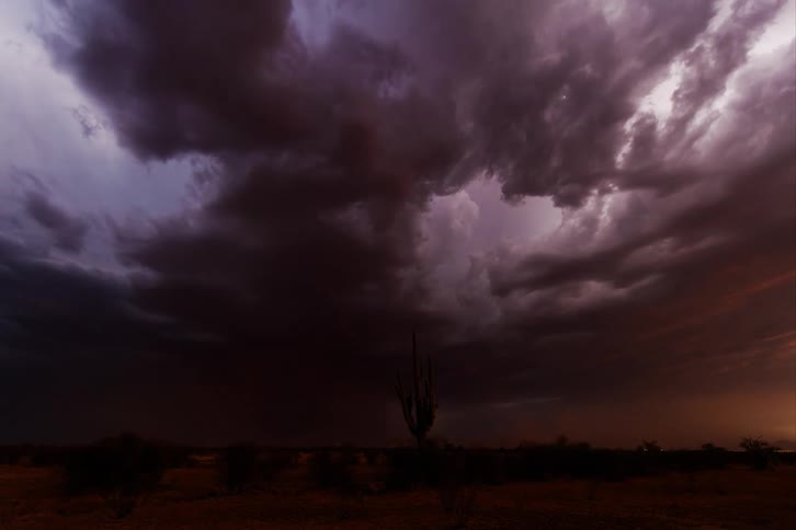 Dramatic sky with dark threatening clouds of an approaching storm over a desert landscape