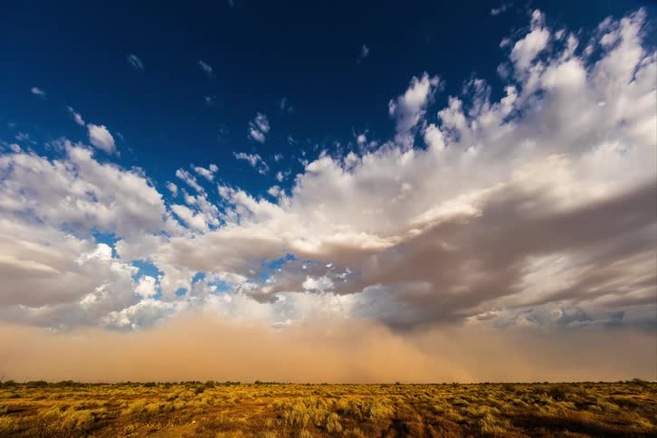 Natural landscape of a field with a storm approaching quickly during the day