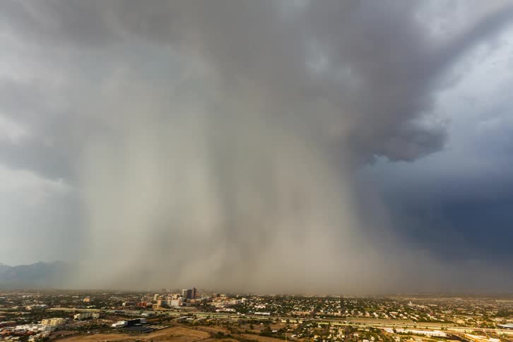 Timelapse of rain and rainbows over a small desert town