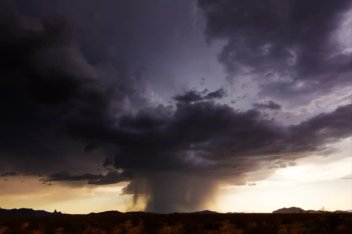 Dramatic microburst in a desert under a stormy sky