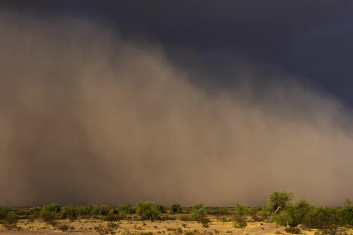 Natural landscape with a dust storm and cloudy sky