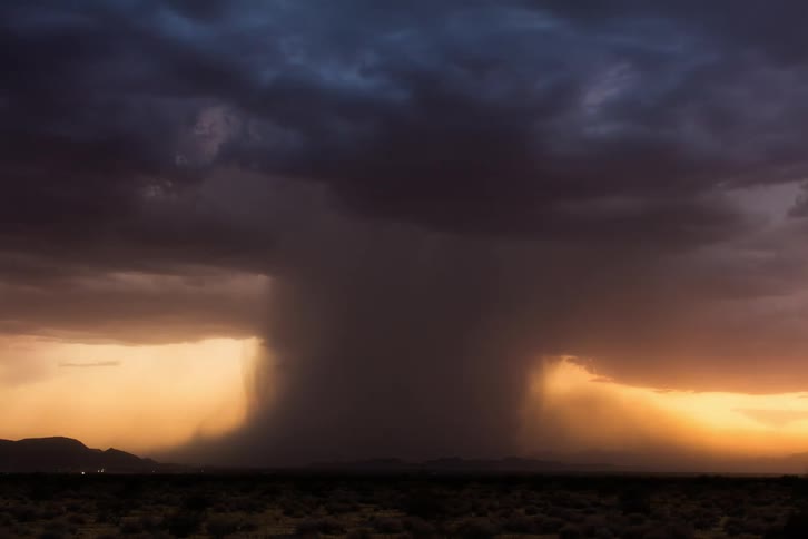 Heavy rain pours from the storm clouds