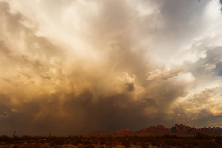 Dramatic sky with dense orange clouds from a dust and rain storm in a desert environment