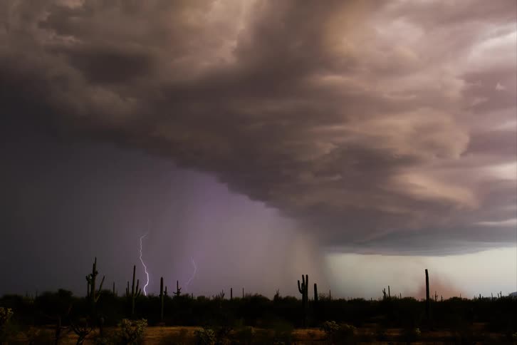 Time lapse of a dramatic desert landscape under a stormy sky with dark heavy clouds