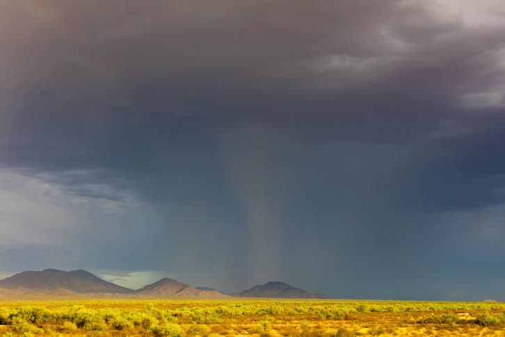 Rainbow shows in the sky in the wake of a storm front moving across the plains