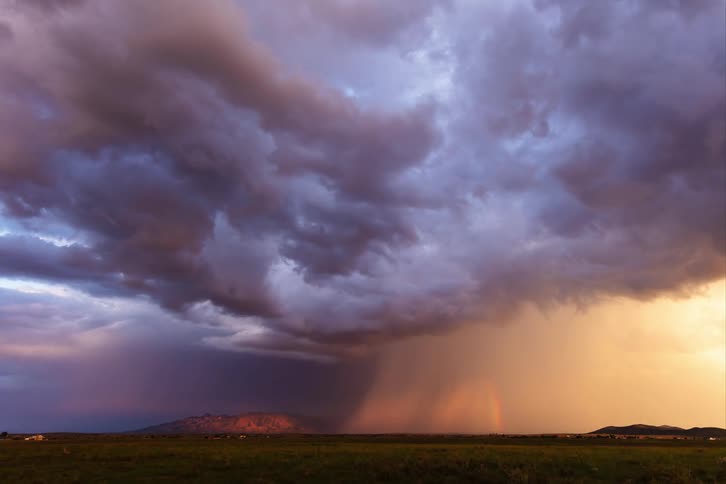 Large storm front moves through the rural countryside during the daytime