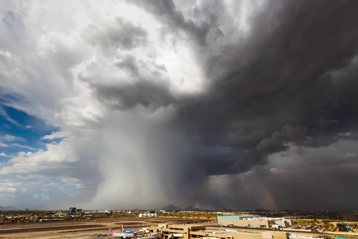Timelapse of rain and rainbows over a small city in the plains