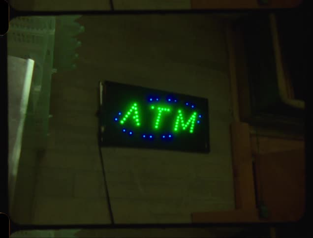 A clip of a refrigerator and a ATM wall light design in a Bodega